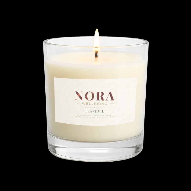 A Nora Wellbeing Tranquil candle with its new label