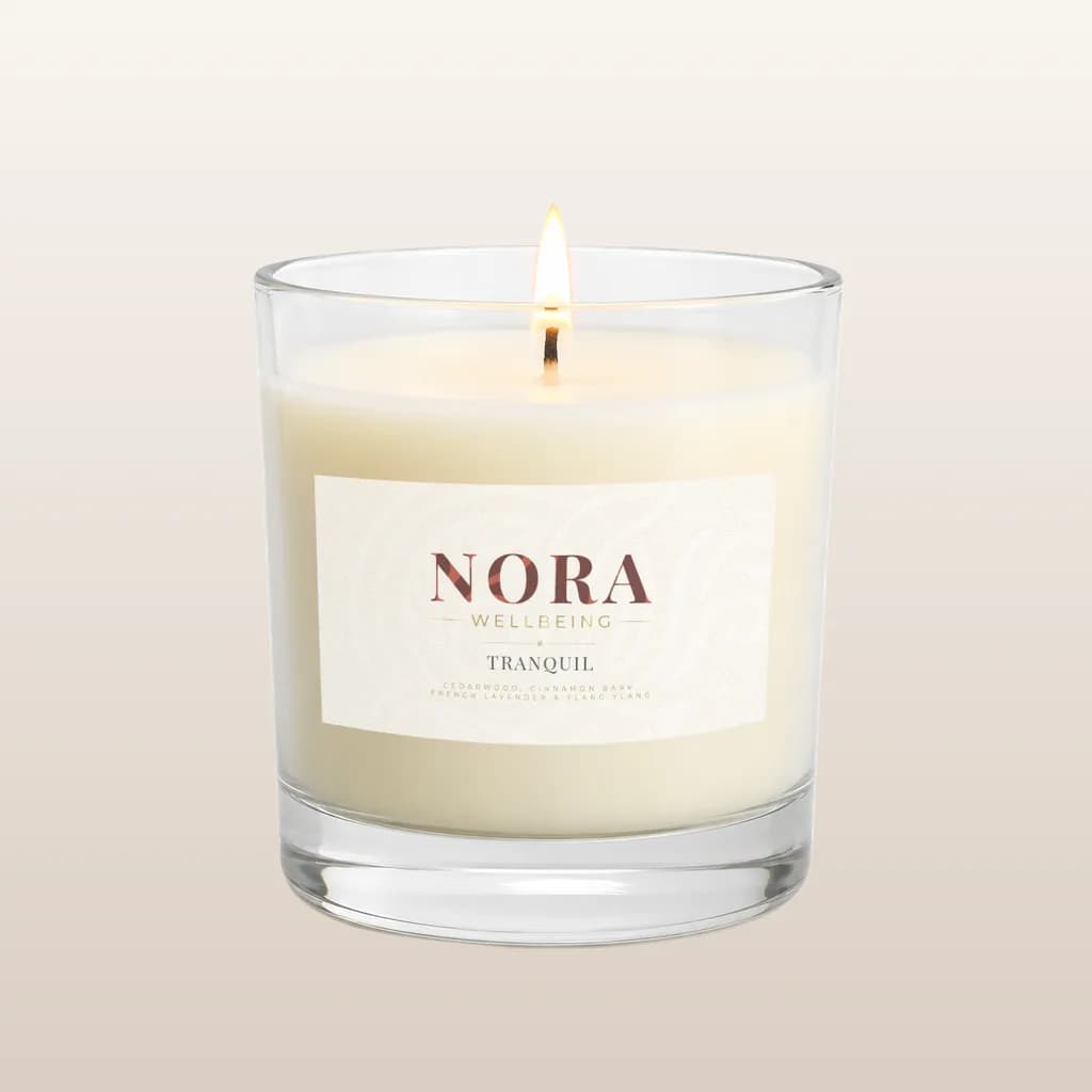 The new Nora Tranquil candle: a cream label with the fine-line NORA Wellbeing logo